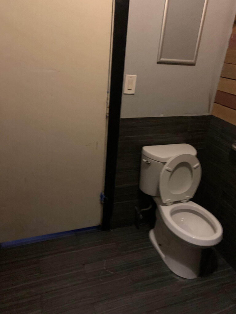Toilet next to a door
