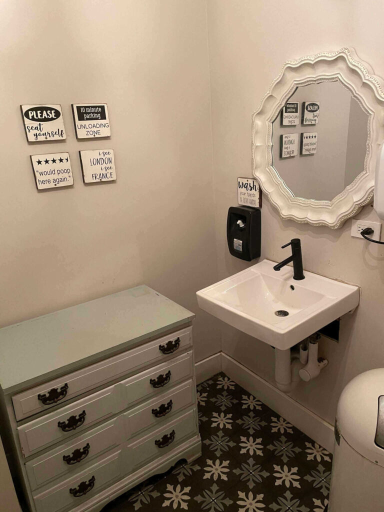 Sink and cabinet in carpeted bathroom