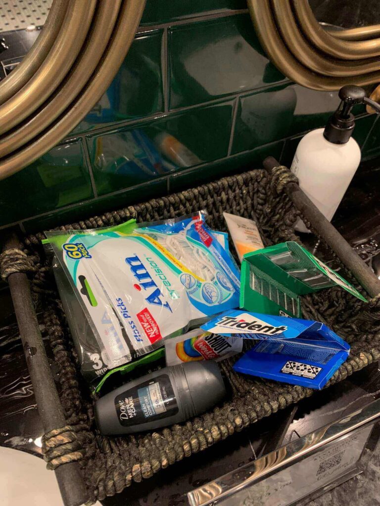 Basket of mints and cologne in a bathroom