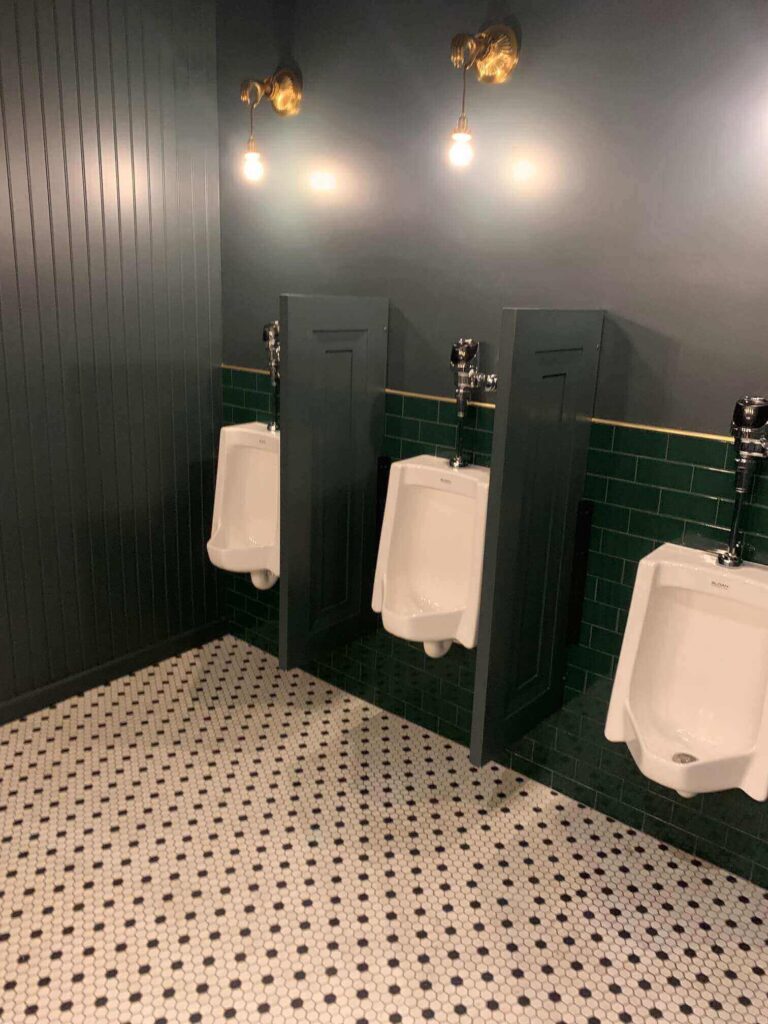 three urinals in a nice bathroom