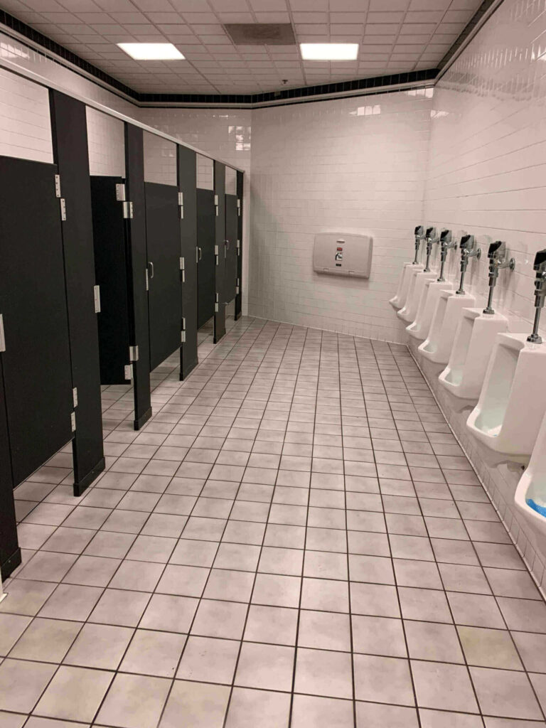 Row of bathroom urinals and stalls